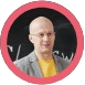 Here's an alt tag for the image: `Headshot of bald man wearing glasses`